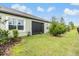 Exterior view of backyard featuring manicured lawn and covered lanai at 6748 Ripple Pond Loop, Zephyrhills, FL 33541