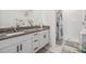 Bright bathroom boasts double sinks, granite counters, and a walk-in shower at 6748 Ripple Pond Loop, Zephyrhills, FL 33541