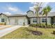 Attractive townhome with a pristine lawn, a convenient two-car garage, and tasteful landscaping at 6748 Ripple Pond Loop, Zephyrhills, FL 33541