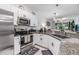 Modern kitchen with granite countertops, stainless steel appliances, and open layout to the living area at 6748 Ripple Pond Loop, Zephyrhills, FL 33541