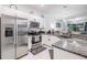 Modern kitchen featuring stainless steel appliances, granite countertops, and ample cabinet space at 6748 Ripple Pond Loop, Zephyrhills, FL 33541