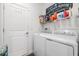 Efficient laundry room with modern appliances and plenty of storage space at 6748 Ripple Pond Loop, Zephyrhills, FL 33541