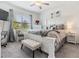 Serene main bedroom with a large bed, plush bedding, and a window overlooking the yard at 6748 Ripple Pond Loop, Zephyrhills, FL 33541