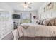 Spacious main bedroom with white furniture, a ceiling fan, and a view of the outdoors at 6748 Ripple Pond Loop, Zephyrhills, FL 33541