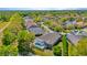 Beautiful aerial view of a home featuring a screened-in pool overlooking a serene pond surrounded by lush landscaping at 7051 Derwent Glen Cir, Land O Lakes, FL 34637