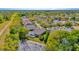 Lovely aerial view of a home with a screened pool, a serene pond, and lush landscaping in a neighborhood at 7051 Derwent Glen Cir, Land O Lakes, FL 34637