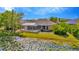 Charming backyard oasis showcasing a screened pool with a tranquil pond view and tropical landscaping at 7051 Derwent Glen Cir, Land O Lakes, FL 34637