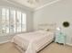 Bedroom with a twin bed, neutral carpeting, and large plantation shutters allowing for plenty of natural light at 7051 Derwent Glen Cir, Land O Lakes, FL 34637