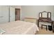 Bedroom showcasing a vanity, bureau, ensuite access, neutral carpeting, and two closets at 7051 Derwent Glen Cir, Land O Lakes, FL 34637