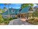 Exterior view of a clubhouse with an inviting entrance, manicured landscaping, and convenient parking at 7051 Derwent Glen Cir, Land O Lakes, FL 34637