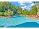 Inviting community pool with clear blue water, lush landscaping, and comfortable lounge chairs for residents at 7051 Derwent Glen Cir, Land O Lakes, FL 34637