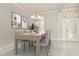 Bright dining room with a chandelier, stylish decor, and ample seating for elegant entertaining at 7051 Derwent Glen Cir, Land O Lakes, FL 34637