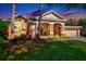 Inviting exterior featuring stone accents, a covered porch with columns, and colorful landscaping at 7051 Derwent Glen Cir, Land O Lakes, FL 34637