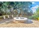 Inviting outdoor fire pit area with stone surround and comfortable seating, great for gatherings at 7051 Derwent Glen Cir, Land O Lakes, FL 34637