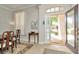 Bright foyer with a decorative glass front door, tile flooring, and elegant decor setting a welcoming tone at 7051 Derwent Glen Cir, Land O Lakes, FL 34637