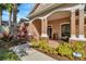 Inviting front porch with stone accents, a seating area, and lush landscaping, perfect for enjoying the outdoors at 7051 Derwent Glen Cir, Land O Lakes, FL 34637