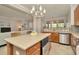Well-appointed kitchen with granite counters, an island with bar seating, and stainless steel appliances for modern convenience at 7051 Derwent Glen Cir, Land O Lakes, FL 34637