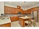 Gourmet kitchen featuring granite countertops, stainless steel appliances, and a center island with seating at 7051 Derwent Glen Cir, Land O Lakes, FL 34637