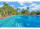 Spacious community lap pool with marked lanes, surrounded by swaying palm trees and ample lounging areas at 7051 Derwent Glen Cir, Land O Lakes, FL 34637