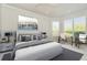 Serene main bedroom with neutral tones, a bay window, and an inviting seating area at 7051 Derwent Glen Cir, Land O Lakes, FL 34637