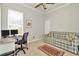 This office space includes a desk setup, as well as a cozy couch for relaxation and a rug to complete the room at 7051 Derwent Glen Cir, Land O Lakes, FL 34637