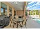 Covered patio featuring ample seating around a glass table, ideal for outdoor dining and relaxing by the pool at 7051 Derwent Glen Cir, Land O Lakes, FL 34637