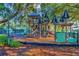 Fun playground area with slides and play structures, nestled under the shade of mature trees at 7051 Derwent Glen Cir, Land O Lakes, FL 34637
