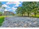 Community sand volleyball court surrounded by trees, offering a recreational space for residents at 7051 Derwent Glen Cir, Land O Lakes, FL 34637