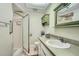 Bright bathroom with tiled floors, glass shower, and white vanity at 7509 Rocky Point Dr, Hudson, FL 34667