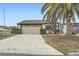 Charming home featuring a large garage, well-maintained landscaping, and a beautiful palm tree at 7509 Rocky Point Dr, Hudson, FL 34667