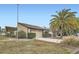 Charming home featuring a large garage, well-maintained landscaping, and a beautiful palm tree at 7509 Rocky Point Dr, Hudson, FL 34667