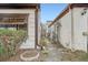 Side view of a charming home featuring beautiful stonework leading to an iron gate at 7509 Rocky Point Dr, Hudson, FL 34667