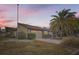 Charming home featuring a large garage, well-maintained landscaping, and a beautiful palm tree at 7509 Rocky Point Dr, Hudson, FL 34667
