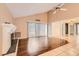 Spacious living room with hardwood floors, fireplace, and ceiling fan at 7509 Rocky Point Dr, Hudson, FL 34667