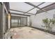 View of the covered patio with sliding glass doors leading inside and a small landscaped area at 7509 Rocky Point Dr, Hudson, FL 34667
