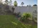 Private backyard featuring lush greenery, flower beds, and a well-maintained fence, creating a peaceful outdoor oasis at 7737 Sail Clover Ln, Zephyrhills, FL 33540