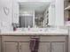 Bathroom featuring dual sinks, vanity with storage, and a decorative mirror with an inspirational quote at 7737 Sail Clover Ln, Zephyrhills, FL 33540