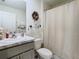 Bathroom featuring a toilet, walk-in shower, vanity, and modern fixtures at 7737 Sail Clover Ln, Zephyrhills, FL 33540