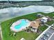 Aerial of the community pool, recreation center, parking and lake in a beautiful community at 7737 Sail Clover Ln, Zephyrhills, FL 33540