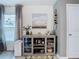 Dining area with a modern display cabinet, decor, and natural light from nearby windows at 7737 Sail Clover Ln, Zephyrhills, FL 33540