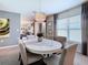 Cozy dining room with modern chandelier lighting fixture and round table seating six at 7737 Sail Clover Ln, Zephyrhills, FL 33540