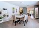 Elegant dining room with a chandelier, a white round table, and plush chairs at 7737 Sail Clover Ln, Zephyrhills, FL 33540