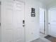 Bright foyer with a white door, a storage bench, decorative mirror and a coat rack at 7737 Sail Clover Ln, Zephyrhills, FL 33540