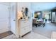 Bright foyer with a console table, decorative mirror, and views of the dining room at 7737 Sail Clover Ln, Zephyrhills, FL 33540