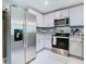 Modern kitchen featuring stainless steel appliances and sleek countertops and cabinetry at 7737 Sail Clover Ln, Zephyrhills, FL 33540