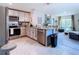 Open concept kitchen with stainless steel appliances, granite countertops, and an eat-in island at 7737 Sail Clover Ln, Zephyrhills, FL 33540