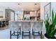 Kitchen island features bar stool seating, pendant lights, and stainless steel appliances at 7737 Sail Clover Ln, Zephyrhills, FL 33540