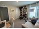 Bright home office with a bookcase, comfortable seating, and ample workspace at 7737 Sail Clover Ln, Zephyrhills, FL 33540