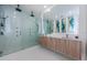 This modern bathroom features a glass shower, double vanity, and contemporary art at 88 Avonwood, Tampa, FL 33625