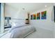 Modern bedroom with neutral decor and artwork, tile floors, and recessed lighting at 88 Avonwood, Tampa, FL 33625